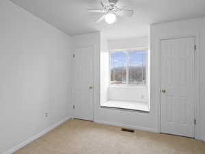 Third upstairs bedroom with window seat, storage underneath and double closets