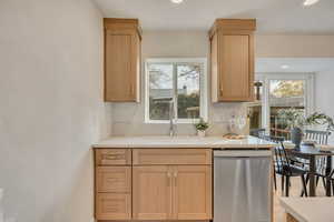 Kitchen with dishwasher, recessed lighting, light brown cabinets, and plenty of natural light