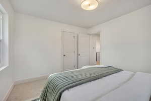 Carpeted bedroom featuring baseboards