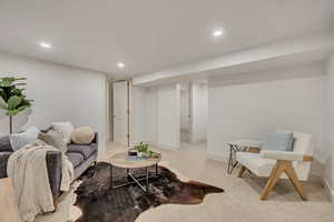 Carpeted living room featuring baseboards and recessed lighting