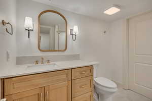 Half bath with vanity and toilet