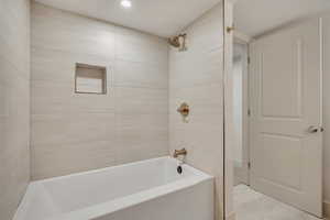 Full bath featuring shower / washtub combination, recessed lighting, and light tile patterned floors