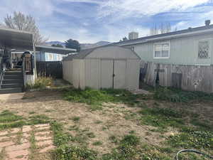 View of yard featuring a storage unit and a mountain view