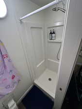 Full bathroom with a shower stall