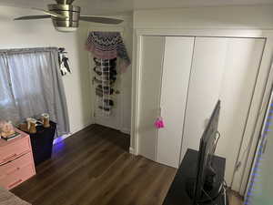 Bedroom featuring dark wood-style floors and a ceiling fan