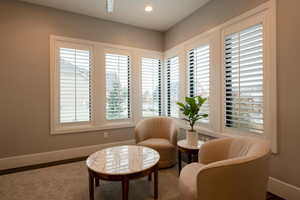 Living area featuring baseboards and recessed lighting