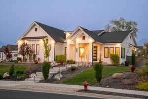 Modern farmhouse style home featuring board and batten siding, a standing seam roof, and a metal roof