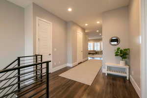 Hallway with recessed lighting and dark wood-type flooring