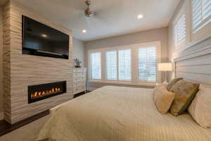 Bedroom with a large fireplace and recessed lighting