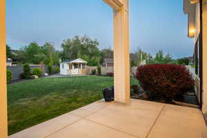 Fenced backyard with an outbuilding
