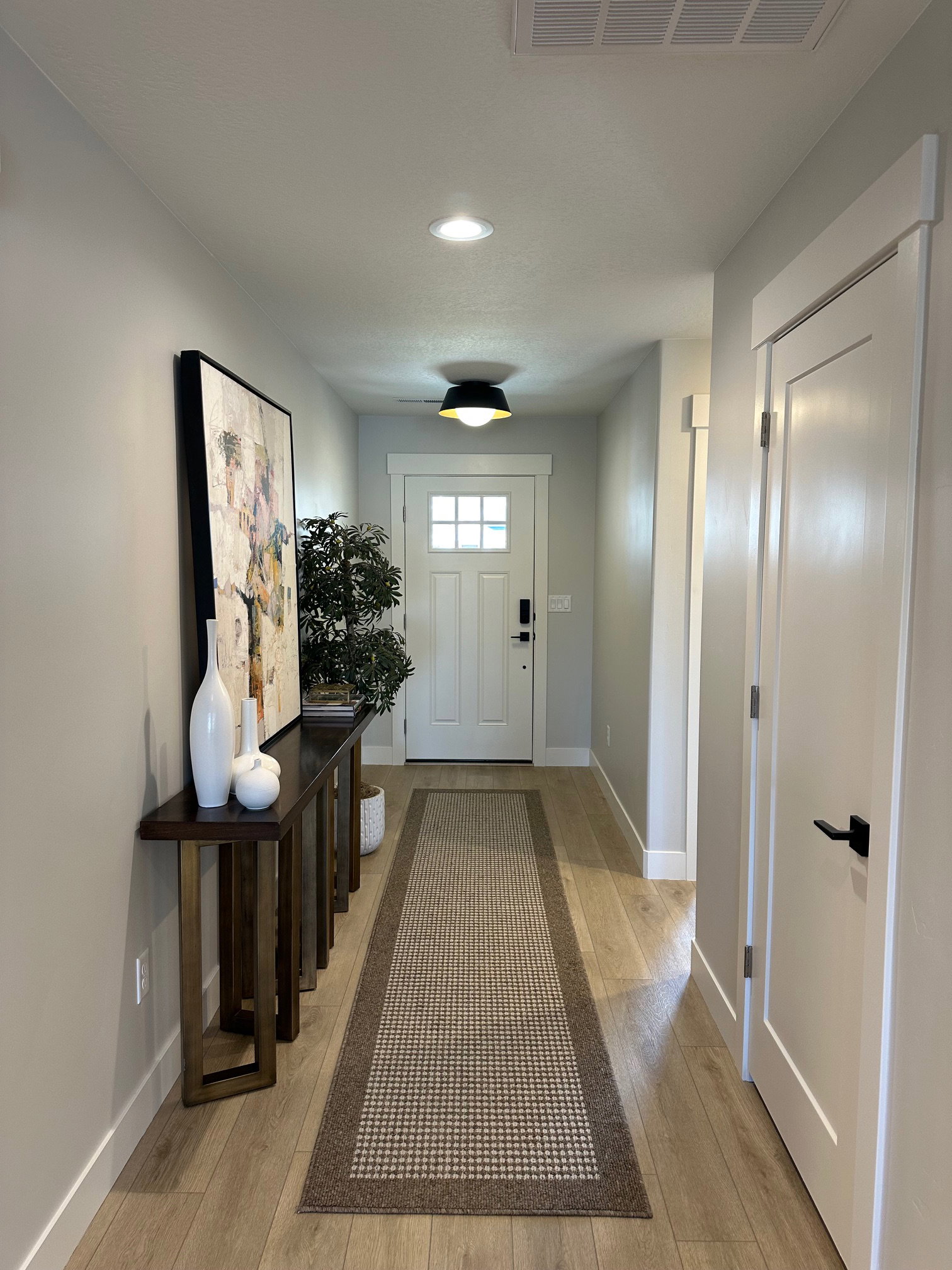 Entrance foyer with light wood-style floors and recessed lighting