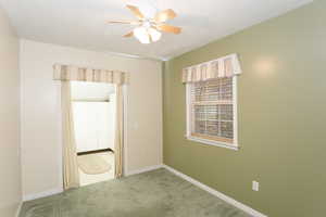 Spare room with carpet floors, a textured ceiling, and a ceiling fan