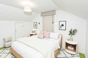 Bedroom featuring vaulted ceiling and baseboards