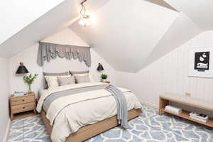 Bedroom with wallpapered walls, lofted ceiling, and carpet floors