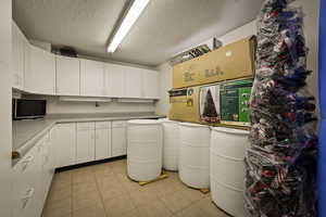 Craft Room with a textured ceiling and light tile patterned floors