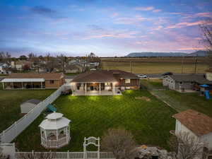 Aerial view at dusk of a rural view, a mountain view, and a residential view