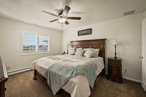 Bedroom with baseboard heating, dark carpet, ceiling fan, and a textured ceiling