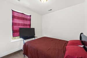 Bedroom featuring baseboards and wood finished floors