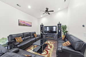 Living area with wood finished floors, recessed lighting, high vaulted ceiling, and a ceiling fan
