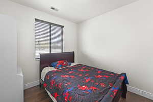 Bedroom featuring wood finished floors and baseboards