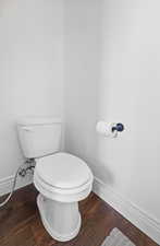 Half bath with dark wood-style flooring