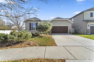 View of front of property with driveway, stucco siding, and a garage