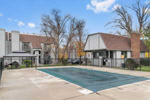 Community pool with a residential view and a gazebo