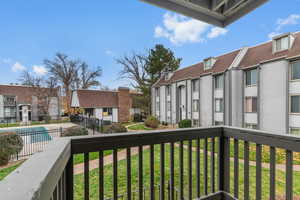 Balcony featuring a residential view and view of pool area