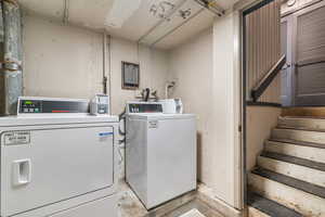Shared laundry room featuring washing machine and dryer
