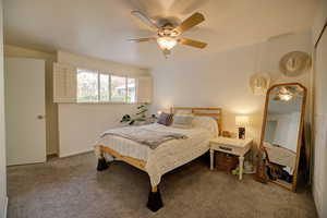 View 2 primary bedroom featuring ceiling fan and large window