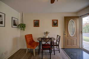 Entry featuring wood finished floors, and storm door