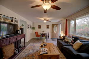 Living room with new laminate flooring, a new paint and baseboards, and ceiling fans