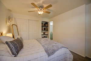 Primary bedroom view 3 to ensuite bath, shelving and double closet