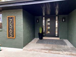 View of exterior entry featuring a custom door with sidelights