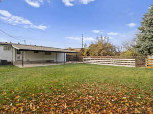 Fenced backyard with a large covered patio