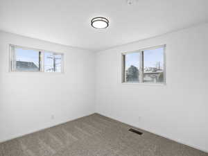 Bedroom with new carpet flooring and plenty of natural light