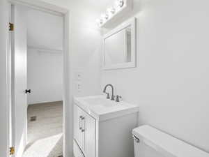 Half bathroom with vanity and light