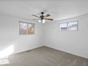 Bedroom with brand new carpet and ceiling fan