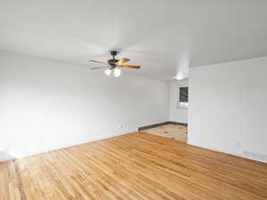 Unfurnished room featuring light wood-type flooring and ceiling fan