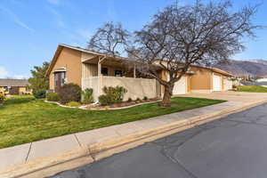 Mid-century home featuring concrete driveway and an attached garage