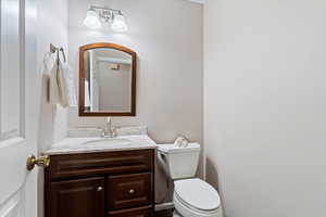 Half bath with vanity and toilet