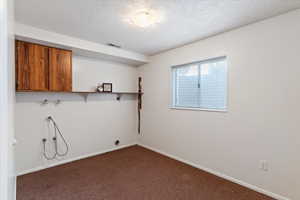 Very nice size laundry room with cabinets
