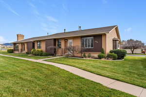 Ranch-style home featuring brick, wood siding, surrounding common area