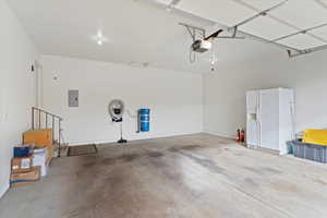 Large 2 automobile Garage featuring central vac, electric panel, and a garage door opener