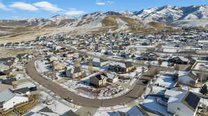Snowy aerial view with a residential view and a mountain view