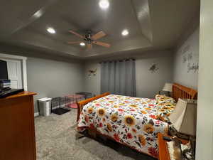 Bedroom with a raised ceiling, carpet flooring, recessed lighting, and a ceiling fan