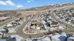 Snowy aerial view with a residential view and a mountain view