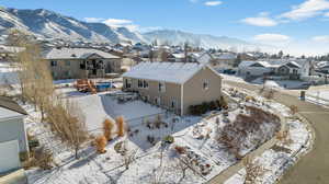 Snowy aerial view with a residential view and a mountain view