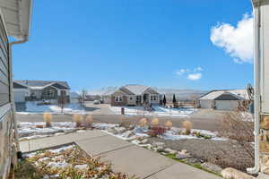 Snow covered patio featuring a residential view