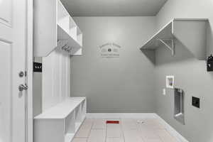 Washroom featuring hookup for a washing machine, electric dryer hookup, and a textured ceiling
